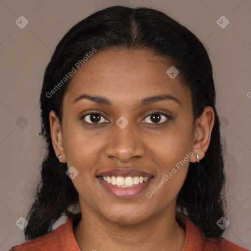 Joyful black young-adult female with long  brown hair and brown eyes