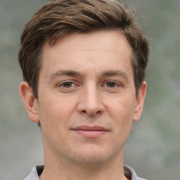 Joyful white adult male with short  brown hair and grey eyes