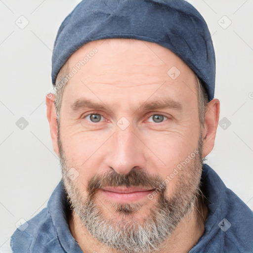 Joyful white adult male with short  brown hair and grey eyes