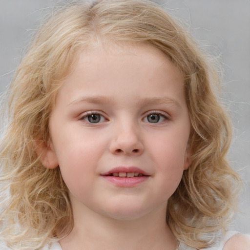 Joyful white child female with medium  brown hair and blue eyes