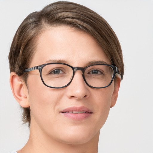 Joyful white young-adult female with short  brown hair and blue eyes