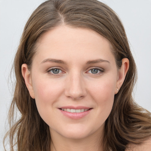 Joyful white young-adult female with long  brown hair and grey eyes