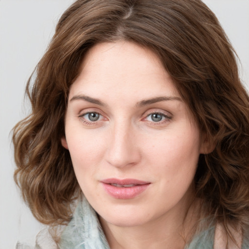 Joyful white young-adult female with medium  brown hair and green eyes