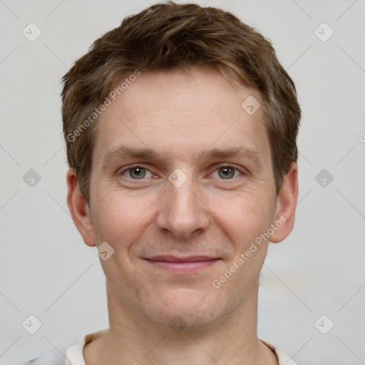 Joyful white adult male with short  brown hair and grey eyes