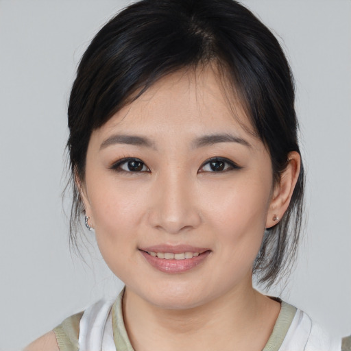 Joyful asian young-adult female with medium  brown hair and brown eyes