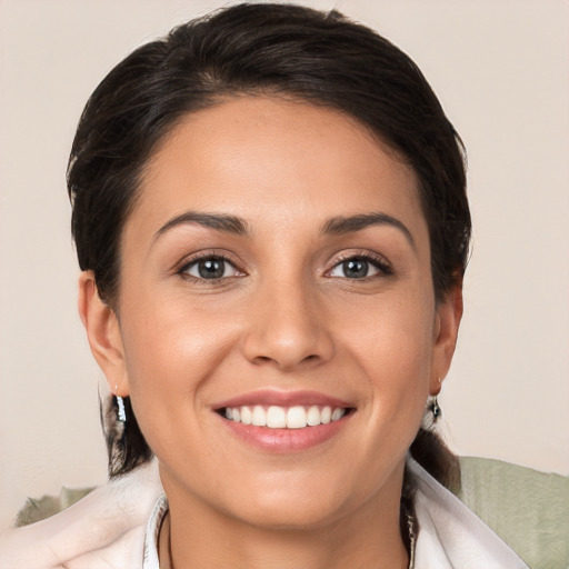 Joyful white young-adult female with medium  brown hair and brown eyes