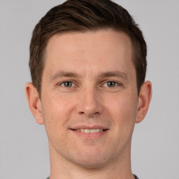 Joyful white adult male with short  brown hair and grey eyes