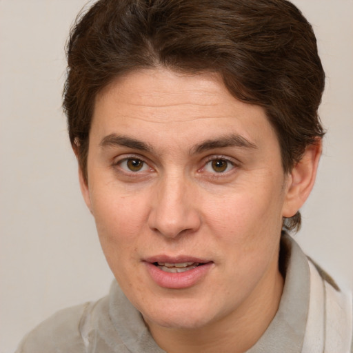 Joyful white adult female with short  brown hair and brown eyes