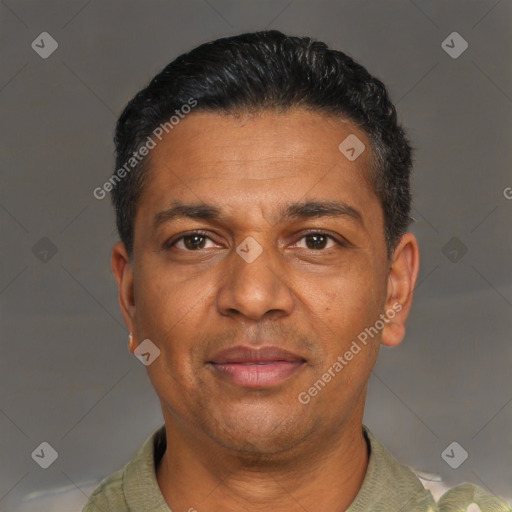Joyful black adult male with short  black hair and brown eyes