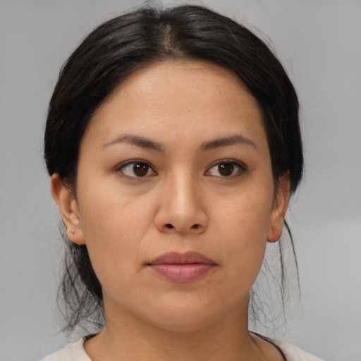 Joyful asian young-adult female with medium  black hair and brown eyes