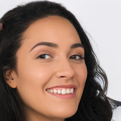 Joyful latino young-adult female with long  brown hair and brown eyes