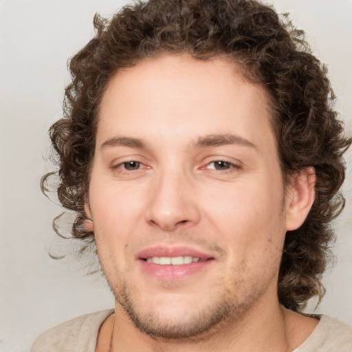 Joyful white young-adult male with medium  brown hair and brown eyes