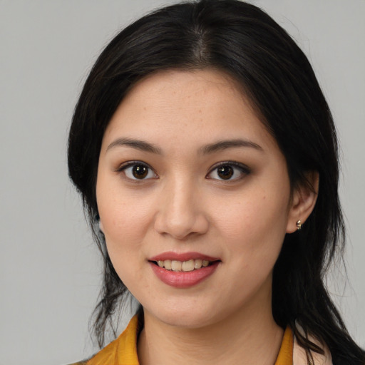 Joyful asian young-adult female with medium  brown hair and brown eyes