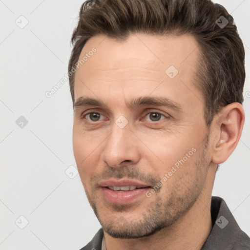 Joyful white adult male with short  brown hair and brown eyes