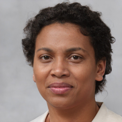 Joyful black adult female with short  brown hair and brown eyes