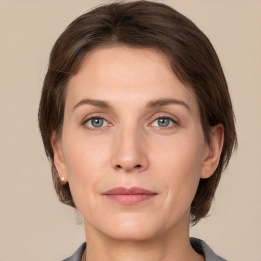 Joyful white adult female with medium  brown hair and grey eyes