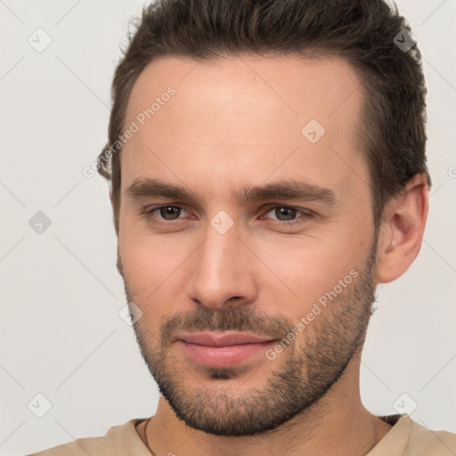 Joyful white young-adult male with short  brown hair and brown eyes