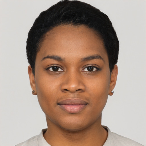 Joyful black young-adult female with short  black hair and brown eyes