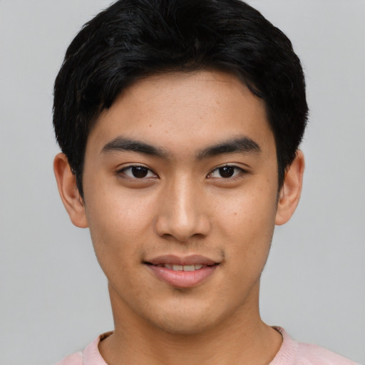 Joyful asian young-adult male with short  black hair and brown eyes