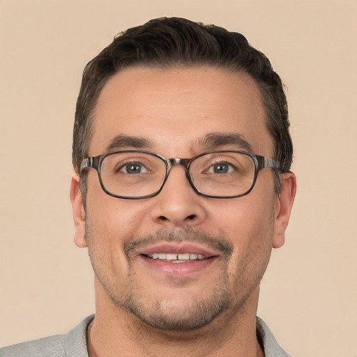 Joyful white adult male with short  brown hair and brown eyes