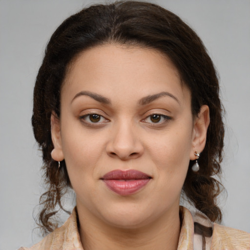 Joyful latino young-adult female with medium  brown hair and brown eyes