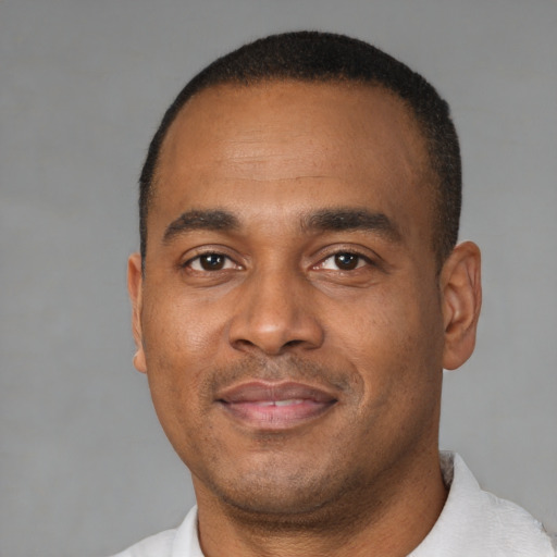 Joyful latino adult male with short  black hair and brown eyes