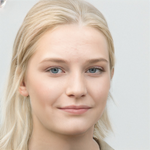 Joyful white young-adult female with long  blond hair and blue eyes