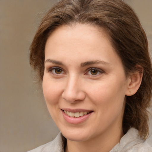 Joyful white young-adult female with medium  brown hair and brown eyes