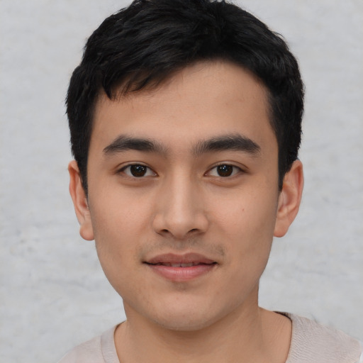 Joyful asian young-adult male with short  black hair and brown eyes