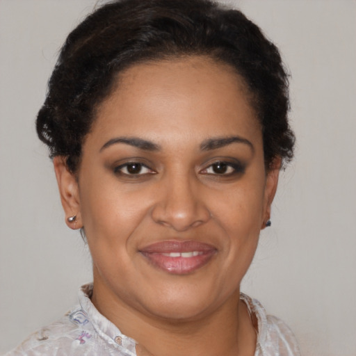 Joyful black young-adult female with short  brown hair and brown eyes