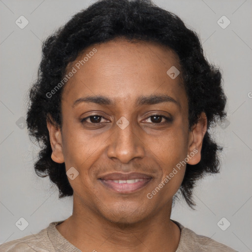 Joyful black adult female with short  black hair and brown eyes