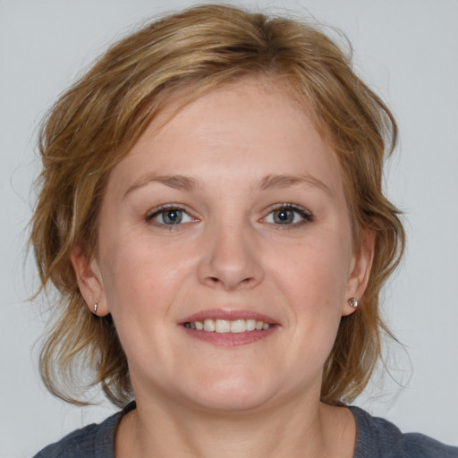 Joyful white young-adult female with medium  brown hair and blue eyes