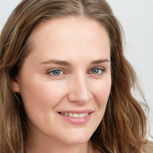 Joyful white young-adult female with long  brown hair and grey eyes