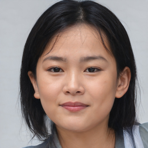 Joyful asian child female with medium  black hair and brown eyes