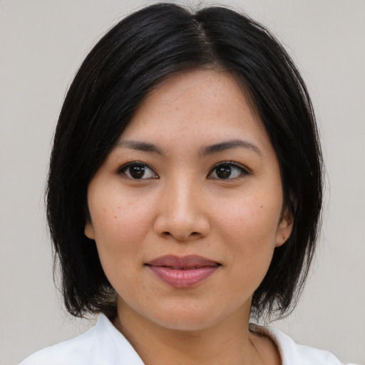 Joyful asian young-adult female with medium  brown hair and brown eyes