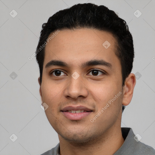 Joyful latino young-adult male with short  black hair and brown eyes