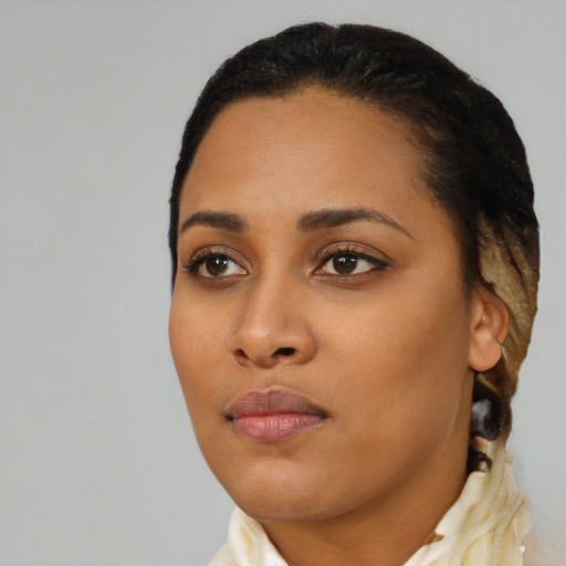 Joyful black young-adult female with short  black hair and brown eyes