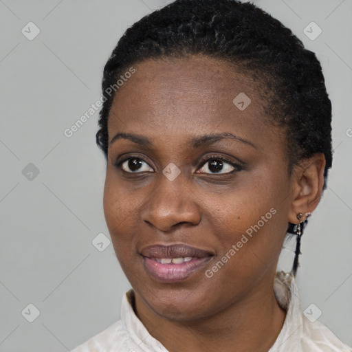 Joyful black young-adult female with short  black hair and brown eyes