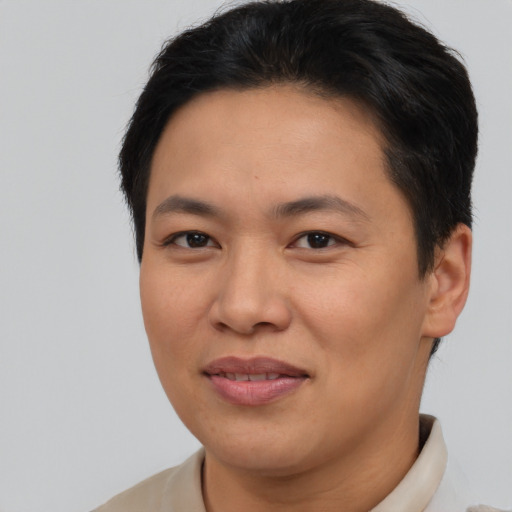 Joyful asian adult female with short  brown hair and brown eyes
