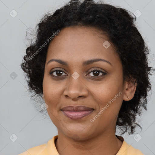 Joyful black young-adult female with long  brown hair and brown eyes