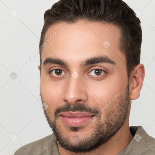 Joyful white young-adult male with short  brown hair and brown eyes