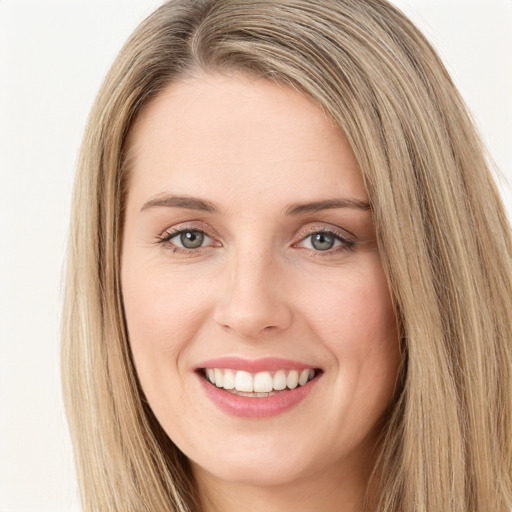 Joyful white young-adult female with long  brown hair and green eyes