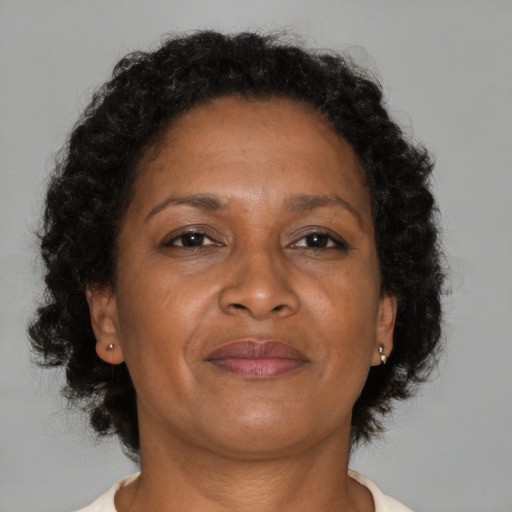 Joyful black adult female with medium  brown hair and brown eyes