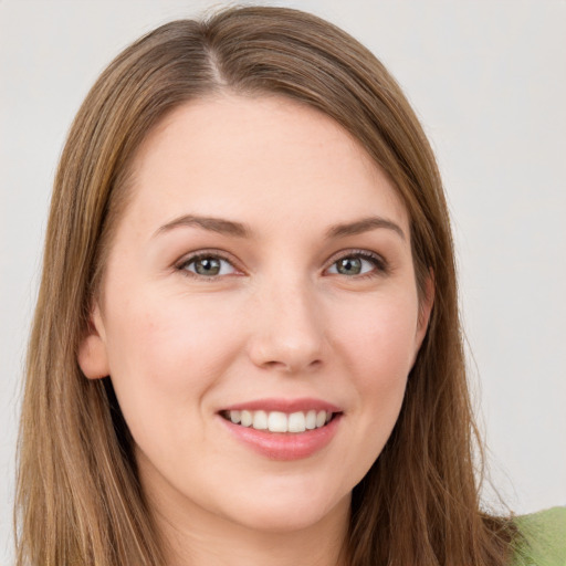 Joyful white young-adult female with long  brown hair and green eyes