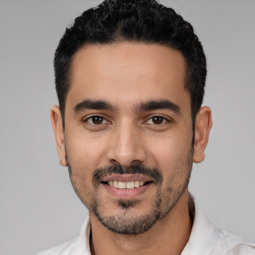 Joyful white young-adult male with short  black hair and brown eyes