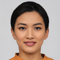 Joyful asian young-adult female with short  black hair and brown eyes