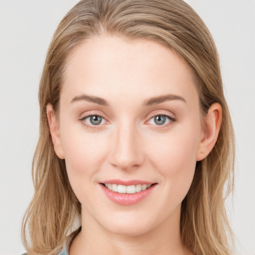 Joyful white young-adult female with long  brown hair and blue eyes