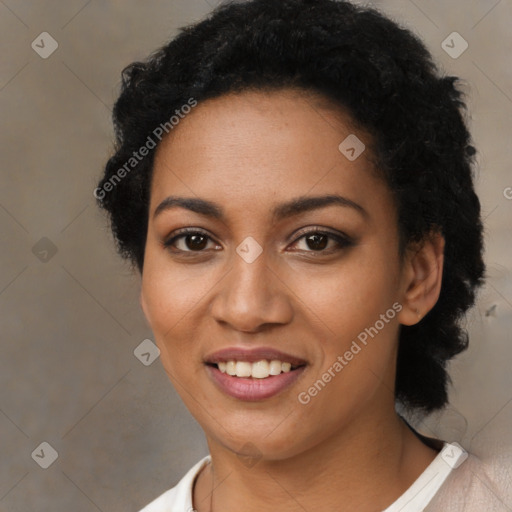 Joyful black young-adult female with short  black hair and brown eyes