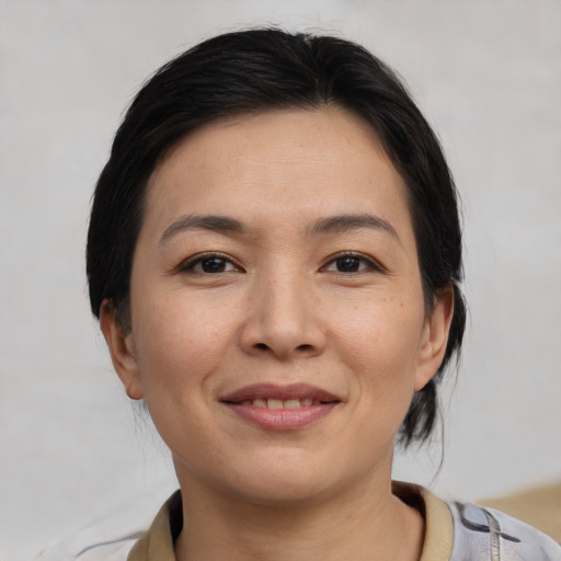 Joyful asian young-adult female with medium  brown hair and brown eyes