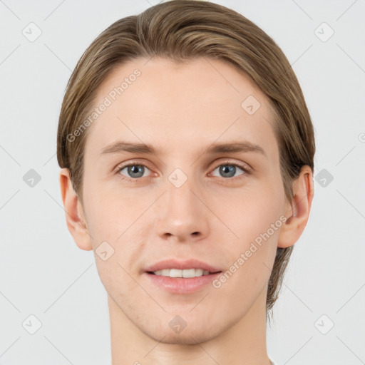 Joyful white young-adult male with short  brown hair and grey eyes